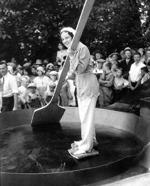 Woman-skating-in-a-skillet-with-slabs-of-bacon-tied-to-her-feet-1